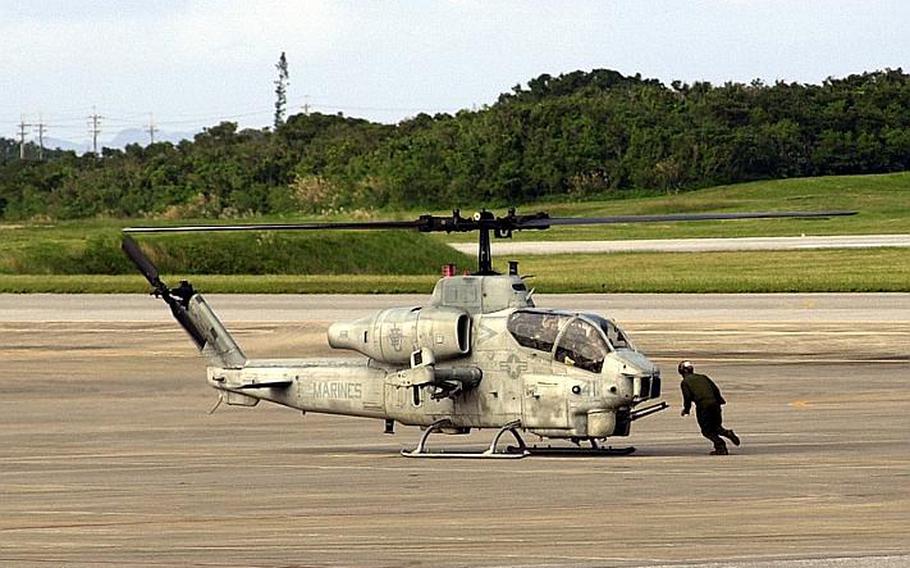 An AH-1W Super Cobra prepares for takeoff Dec. 2, 2011, at Marine Corps Air Station Futenma. Congress wants to study whether the helicopters and other air operations could be moved up the road to Kadena Air Base.