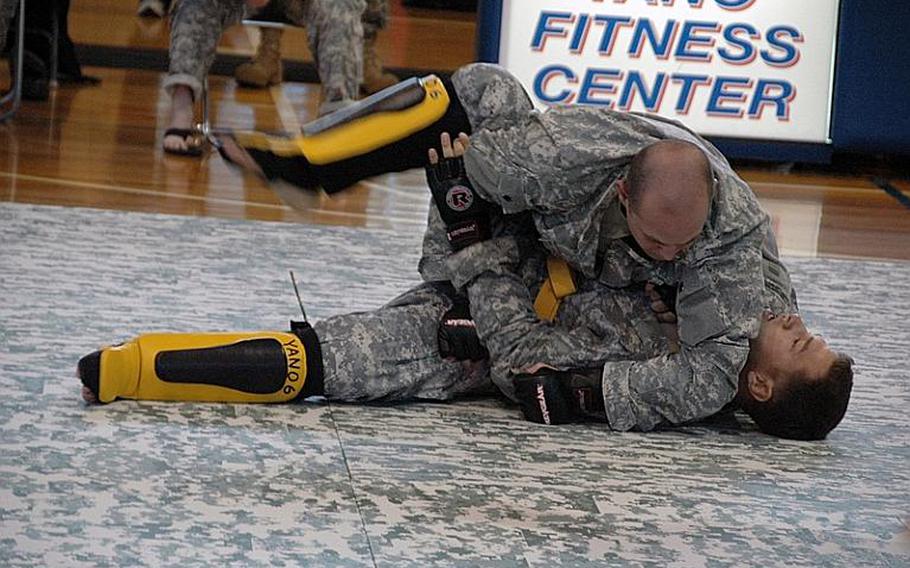 Sgt. Maximillan Curtner, top, wrestles Staff Sgt. Christopher Hogan during an Army Combatives tournament at Camp Zama in December 2011. Curtner finished second in the heavyweight division while Hogan placed third. 