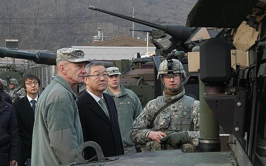 Sgt. David Hutchinson, right, explains some of the attributes of a Humvee to South Korean Foreign Minister Kim Sung-hwan, center, as 2nd Infantry Division commander Maj. Gen. Edward Cardon, left, listens Friday at Camp Casey in South Korea. Kim visited the base to thank troops for their efforts to keep peace on the Korean peninsula.