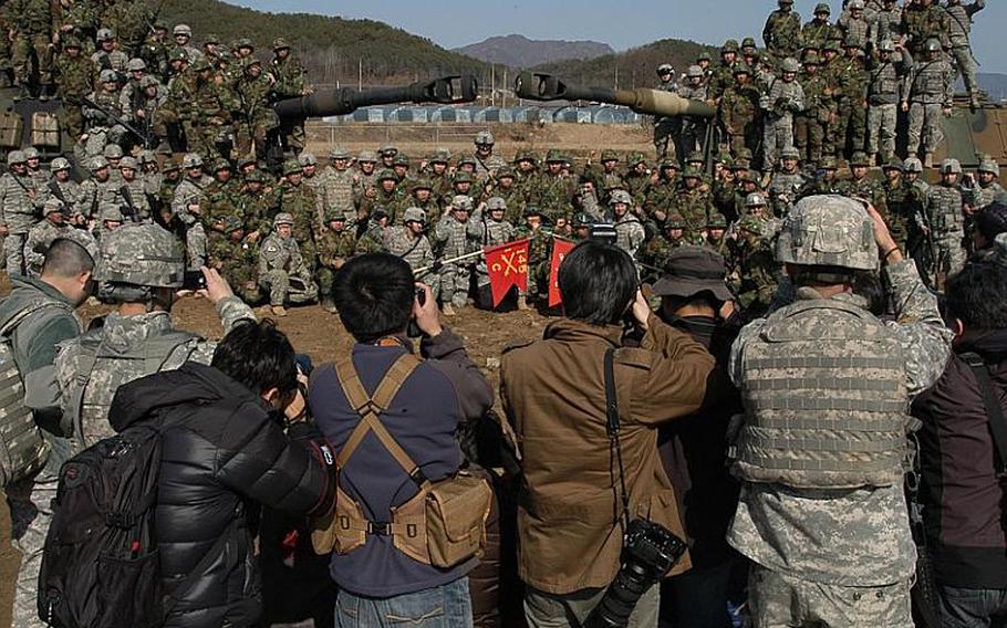 U.S. and South Korean soldiers pose for the media after a joint live-fire exercise Thursday near the Demilitarized Zone. The drill was part of Foal Eagle, the largest U.S.-South Korean joint military exercise on the peninsula every year, and one of the few open to the media.