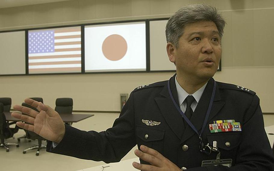 Col. Kourta Tanaka shows reporters around the bilateral operations center in the basement of the 1.3 million square-foot Air Defense Command headquarters building, located next to the headquarters of U.S. Forces Japan and 5th Air Force.