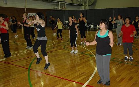 Women take part in a Zumba group exercise class at Yokota Air Base last month. Thanks to cuts in the defense budget, Yokota's Samurai Fitness Center has started charging a $3 fee for some classes. Quality-of-life programs throughout the Pacific are facing cutbacks as a result of the dwindling defense dollars.


