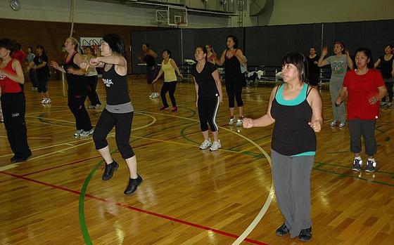 Women take part in a Zumba group exercise class at Yokota Air Base last month. Thanks to cuts in the defense budget, Yokota's Samurai Fitness Center has started charging a $3 fee for some classes. Quality-of-life programs throughout the Pacific are facing cutbacks as a result of the dwindling defense dollars.


