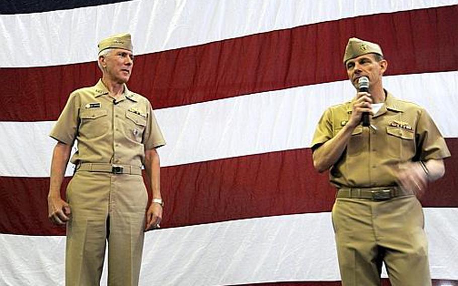 Rear Adm. J.R. Haley of Commander Task Force 70, right, introduces Adm. Samuel Locklear, commander of the U.S. Pacific Command, at the start of an all-hands meeting April 12, 2012, with sailors aboard the aircraft carrier USS George Washington at Yokosuka Naval Base, Japan.