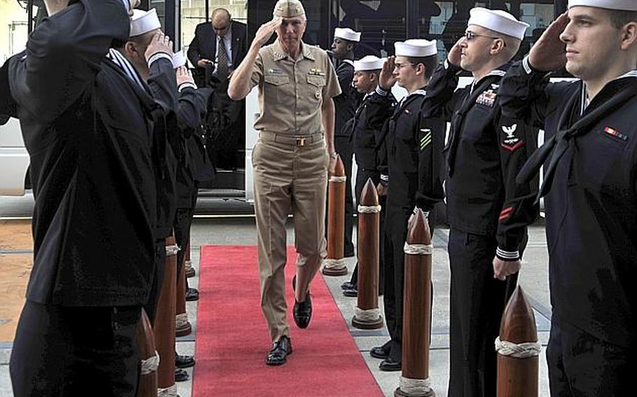 Sailors salute Adm. Samuel Locklear, commander of the U.S. Pacific Command, as he arrives for an all-hands meeting with sailors aboard the aircraft carrier USS George Washington at Yokosuka Naval Base, Japan, on April 12, 2012.