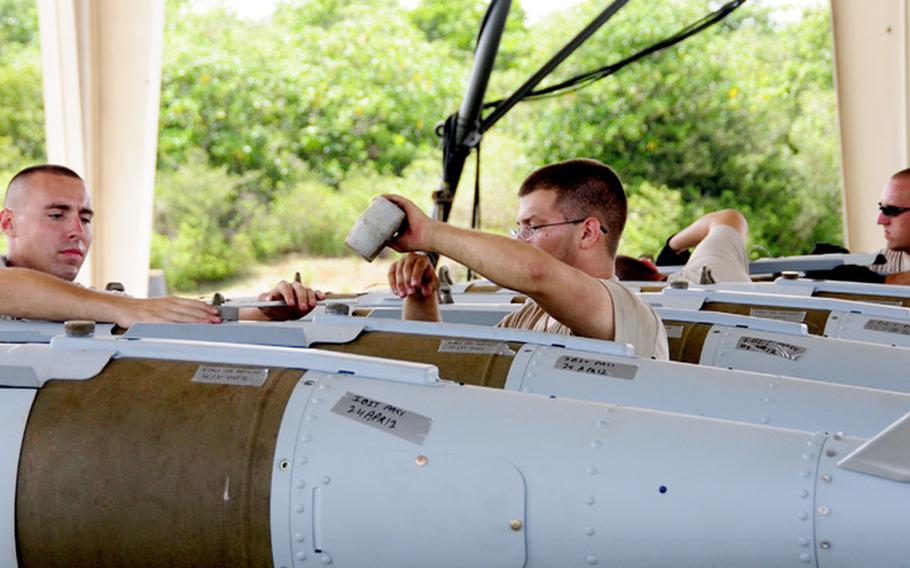 Airmen from the 36th Munitions Squadron build Mark-84 bombs during a Combat Ammunition Production Exercise on April 24, 2012 at Andersen Air Force Base, Guam. The exercise tested the squadron&#39;s munitions production capabilities under possible real world scenarios.
