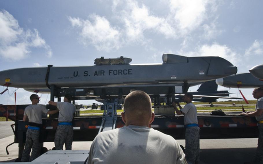 Airmen prepare to lift and transport a training Conventional Air-Launched Cruise Missile during a Combat Ammunition Production Exercise at Andersen Air Force Base, Guam, on April 23, 2012.