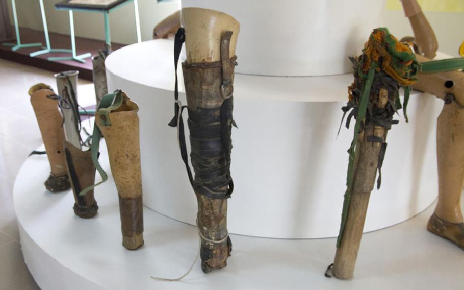 These homemade prosthetic limbs were collected by Project Renew, which aids UXO victims with high-quality prosthetics. Some makeshift limbs were fashioned from bombshell casings.
