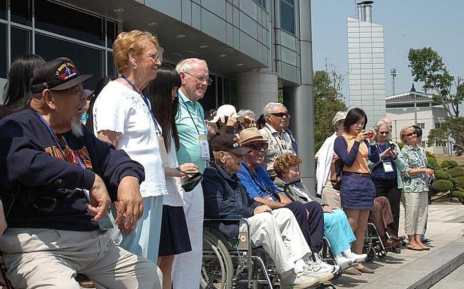 A group of U.S. Korean War veterans, accompanied by their families and South Korean students, visit the Joint Security Area of the Demilitarized Zone on May 23, 2012.