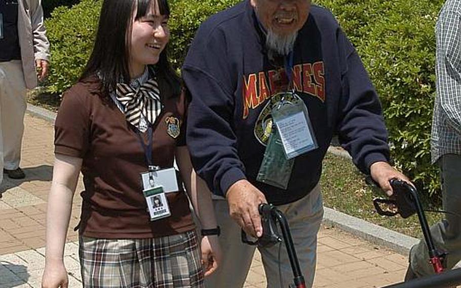 Richard Lee Sung, 81, is accompanied by a South Korean schoolgirl during a tour U.S. Korean War veterans took Wednesday in and around the Demilitarized Zone. Sung, who served with the 1st Marine Division during the war, went on to appear numerous times as an actor on ""M*A*S*H", a television show about the Korean War.