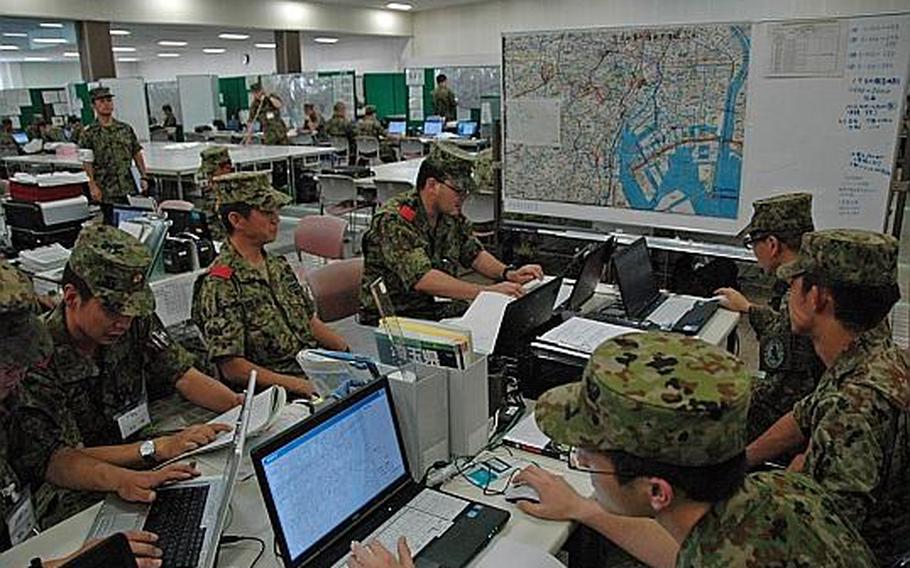 Japanese troops plan relief convoys during an exercise July 19, 2012, designed to test the ability of U.S. and Japanese forces to repond to a massive earthquake in Tokyo.
