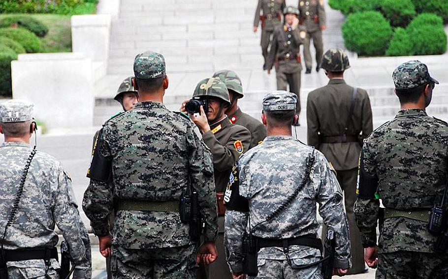 A North Korean soldier takes a close-up photo of U.S. and South Korean soldiers lined up on the opposite side of the Military Demarcation Line dividing the two Koreas July 27, 2012. The allied soldiers were preparing to protect U.S. Forces Korea commander Gen. James Thurman and other dignitaries who were about to pose for photos of their own after a ceremony marking the 59th anniversary of the armistice that effectively ended the Korean War.