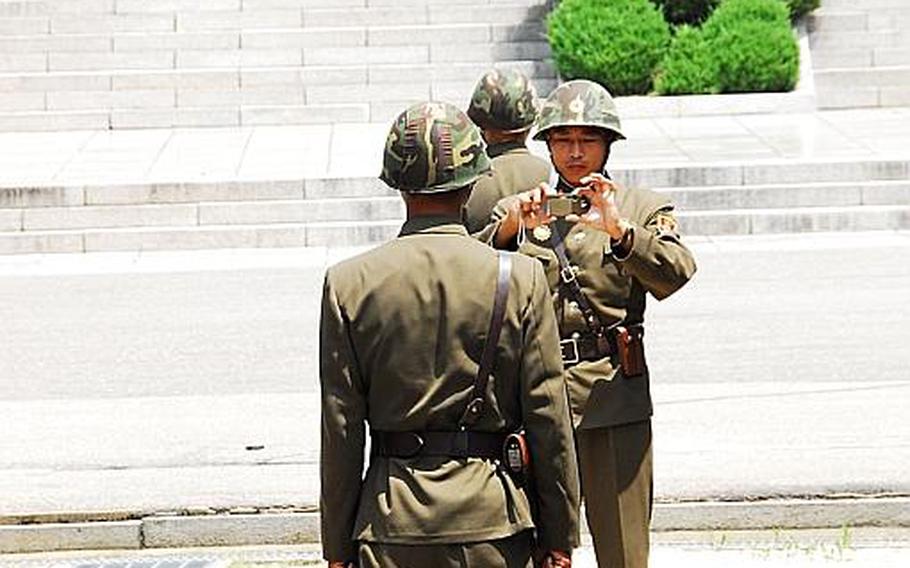 A North Korea soldier takes a photo of one of his colleagues July 27, 2012, just north of the Military Demarcation Line after a number of dignitaries from the U.S., South Korea and other countries posed for photos near the line that divides the two Koreas.