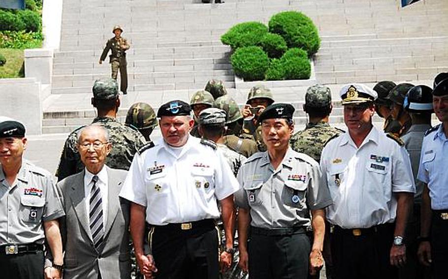 U.S. Forces commander Gen. James Thurman, center, poses for photos with other dignitaries at the Military Demarcation Line in Korea on July 27, 2012. The show of bravado and gamesmanship in front of a tour group massed on the North Korea side of the line followed a ceremony at the DMZ marking the 59th anniversary of the armistice that effectively ended the Korean War.