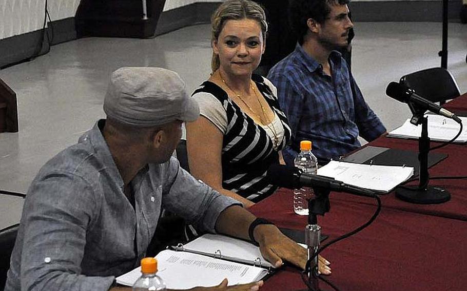 In front of an audience of soldiers and civilians at Camp Zama on Sept. 27, 2012, Theater of War actors Glenn Davis and Ana Reeder prepare for a reading of the Greek tragedy "Ajax" by Sophocles. Theater of War performs such classic plays to sensitize military audiences to the psychological injuries of war, and to elicit talk on the hardships unique to military families.