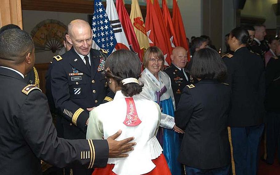 Maj. Gen. Edward Cardon greets guests at a reception Sept. 27, 2012, at Camp Casey in South Korea to celebrate the Chuseok, a Korean holiday similar to Thanksgiving in the U.S. With Cardon is his wife Linda, dressed in a Korean hanbok.