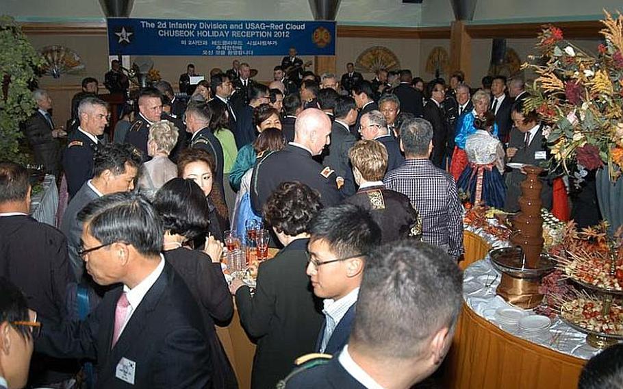 Guests mingle at a reception Sept. 27, 2012, to mark the upcoming Chuseok holiday at Camp Casey in South Korea. More than 250 people attended.
