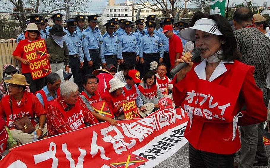 Keiko Itokazu, a member of Japan's parliament, tells protesters Oct. 1, 2012, that she is enraged by the United States and Japan for following through with the deployment of Osprey aircraft despite widespread opposition on Okinawa. The protesters have chosen to wear the color red as a way to show opposition the aircraft's deployment.