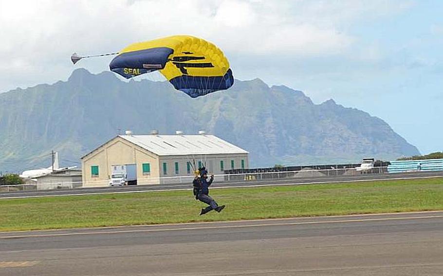 A member of the U.S. Navy Parachute Team "Leap Frogs" lands on the airstrip during the Kaneohe Bay Air Show on Sept. 30, 2012, at Marine Corps Base Hawaii. The event starred the Navy's Blue Angels, as well as a host of other aviators and parachutists.