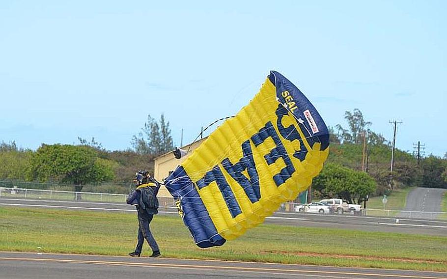 A member of the U.S. Navy Parachute Team "Leap Frogs" walks away from the airstrip following a skydive. during the Kaneohe Bay Air Show on Sept. 30, 2012, at Marine Corps Base Hawaii. The event starred the Navy's Blue Angels, as well as a host of other aviators and parachutists.