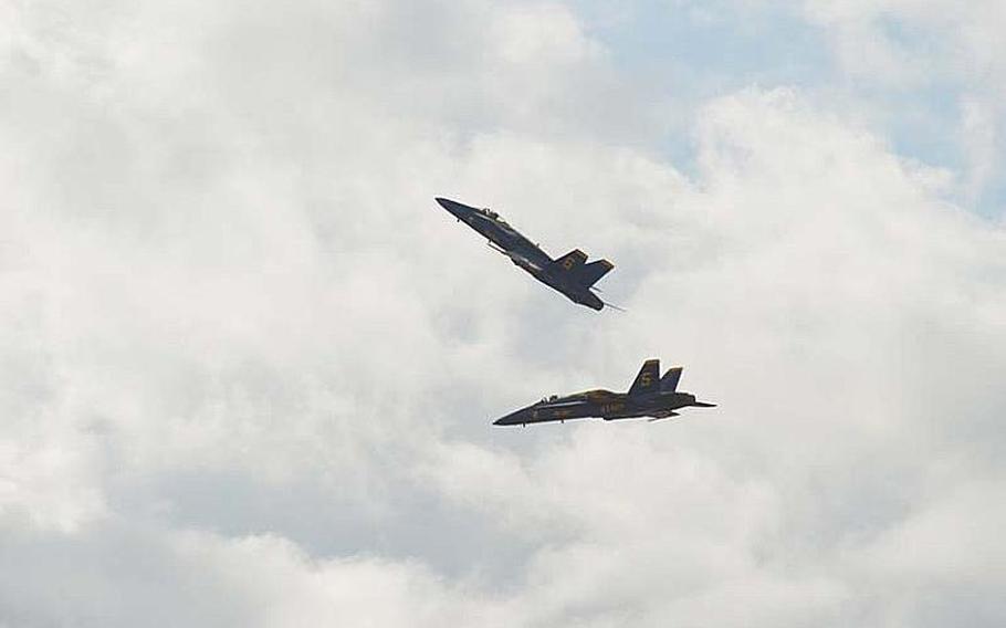 Two members of the Blue Angels fly in a close pattern during the Kaneohe Bay Air Show on Sept. 30, 2012, at Marine Corps Base Hawaii. Tens of thousands of spectators turned out at Kaneohe Bay to watch the Navy aerobatic team, along with other aviators and parachutists.