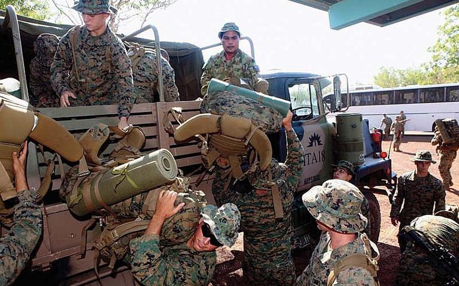 U.S. Marines from the 31st Marine Expeditionary Unit, with help from Australian Defence Force members, unload gear from an Australian military vehicle at the beginning of a bilateral exercise in Darwin on Aug. 1, 2012. A recent survey determined that the Marines were perfect guests during the deployment, adding about $1.8 million into the local economy.