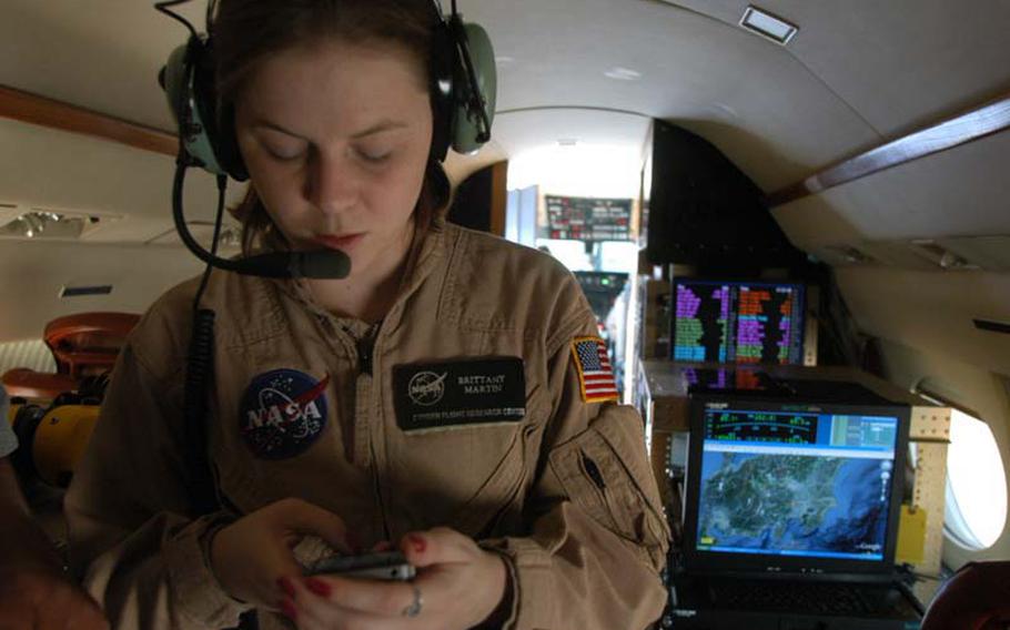 Operations engineer Brittany Martin prepares to leave Yokota Air Base, Japan, on Oct. 8, 2012, sending a last-minute email to the ground crew to change the flight manifest to allow another scientist to partake in the flight. It was the last mission the team of scientists, engineers and pilots flew from Yokota before returning to the Dryden Flight Research Center in California the next morning.