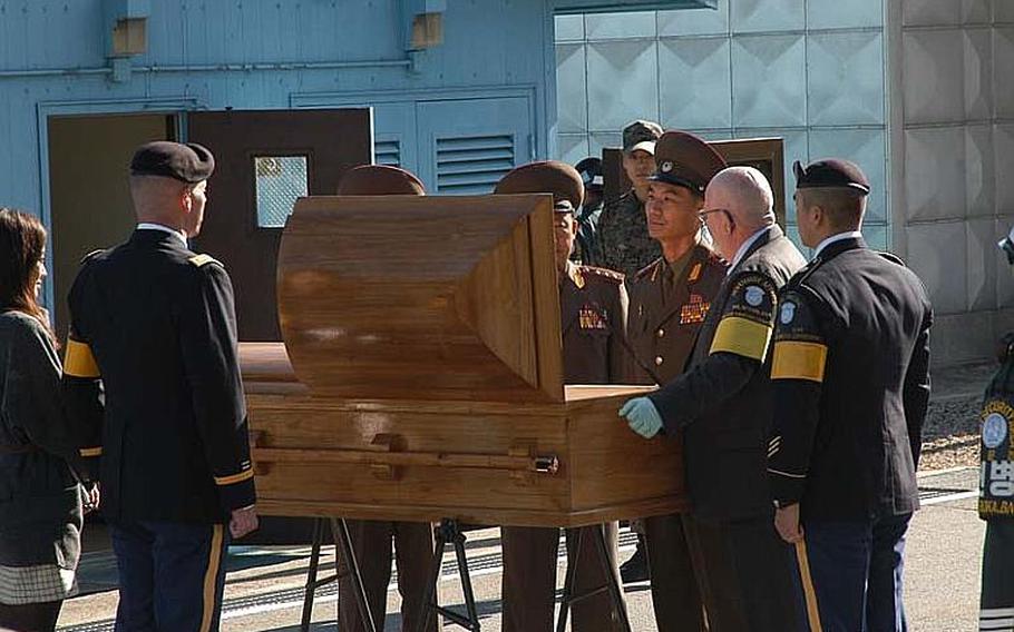 North Korean officers on Oct. 18, 2012, inspect the remains of a North soldier whose body was found south of the line dividing the two Koreas during a repatriation ceremony in the Joint Security Area of the Demilitarized Zone.