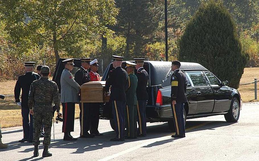 The United Nations Command Honor Guard unloads a casket containing the remains of a North Korean solider from a hearse during a repatriation ceremony on Oct. 18, 2012, in the Joint Security Area of the Demilitarized Zone.