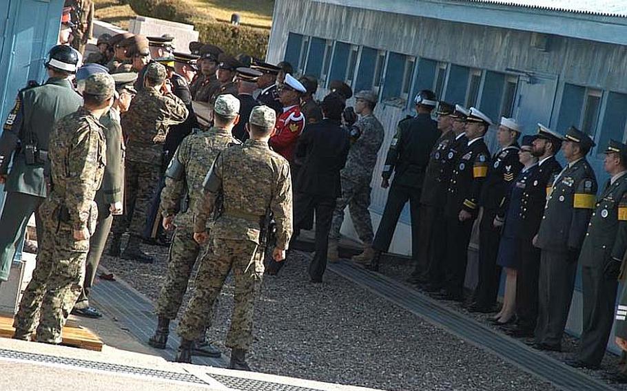 A casket containing the remains of a North Korea soldier is passed across the Military Demarcation Line from the United Nations Command Honor Guard to a group of North soldiers during a repatriation ceremony Oct. 18, 2012, in the Demilitarized Zone.