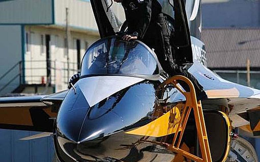 A Republic of Korea Air Force Black Eagles pilot climbs into his T-50B in preparation of a practice air demonstration at Osan Air Base, South Korea on Oct. 18, 2012. The demonstration team is expected to perform at Osan Power Day 2012 this weekend.