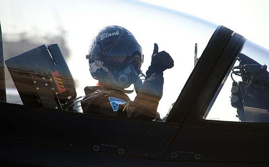 A Black Eagles pilot in his T-50B gives a thumbs-up to a Republic of Korea Air Force ground personnel at Osan Air Base, South Korea on Oct. 18, 2012.