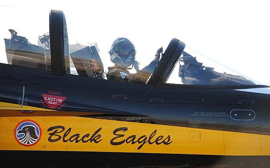 A Black Eagles pilot in his T-50B waves to a Republic of Korea Air Force ground personnel at Osan Air Base, South Korea on Oct. 18, 2012.