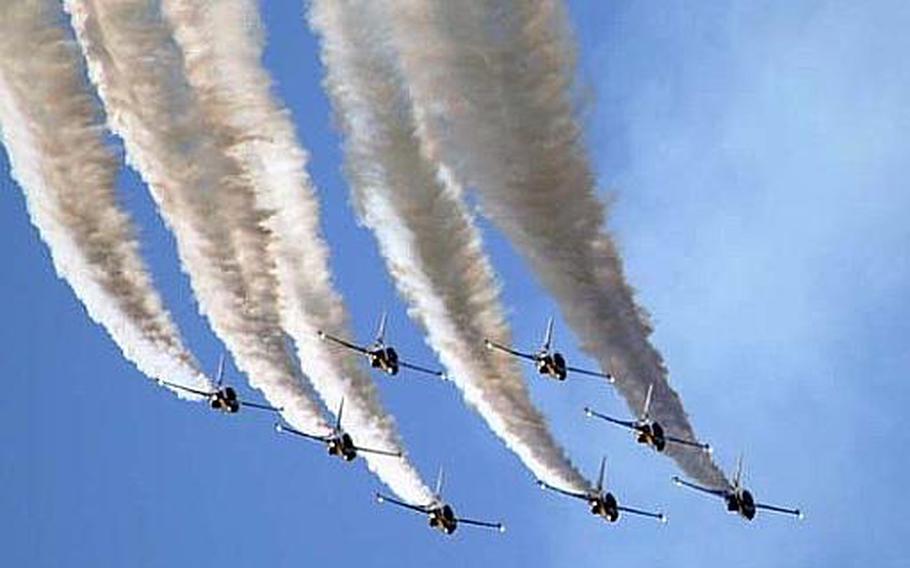 The aerobatic team of eight Republic of Korea Air Force Black Eagles leaves a trailing white smoke behind during a practice aerial demonstration over Osan Air Base, South Korea, on Oct. 18, 2012. The aerial demonstration team is expected to perform at this weekend&#39;s Osan Air Power Day 2012 event.