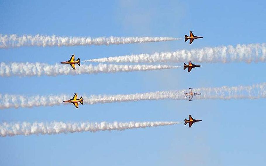 Republic of Korea Air Force Black Eagles pass by each other during a practice aerial demonstration at Osan Air Base, South Korea on Oct. 18, 2012. The team will perform at this weekend&#39;s Osan Air Power Day 2012.