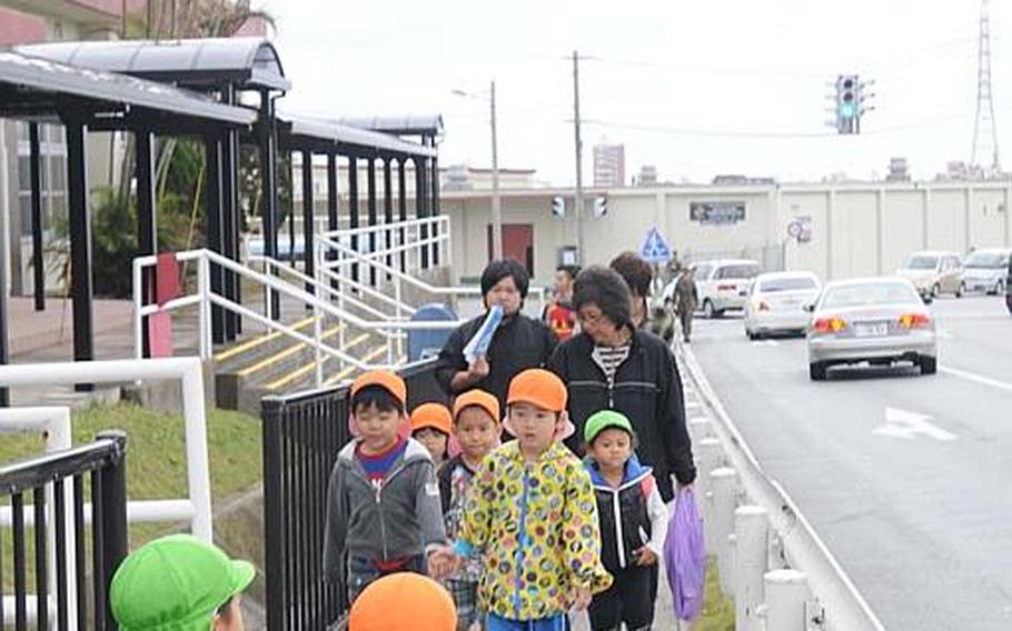 Children from local day care centers join in a disaster drill Nov. 5, 2012, on Camp Foster. The Marine Corps and two local communities that host Marine Corps Air Station Futenma and Camp Foster exchange an agreement; enabling local residents to gain access to the two Marine installations to evacuate for higher elevations should a major disaster hit the island prefecture.