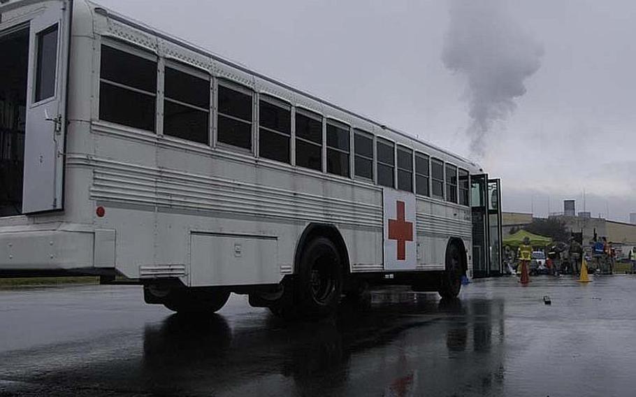 An ambulance bus waits on the flight line on Nov. 6, 2012, during a during a disaster response training exercise at Yokota Air Base, Japan. The "am bus" is a passenger bus fitted with emergency medical equipment used to transport multiple patients.