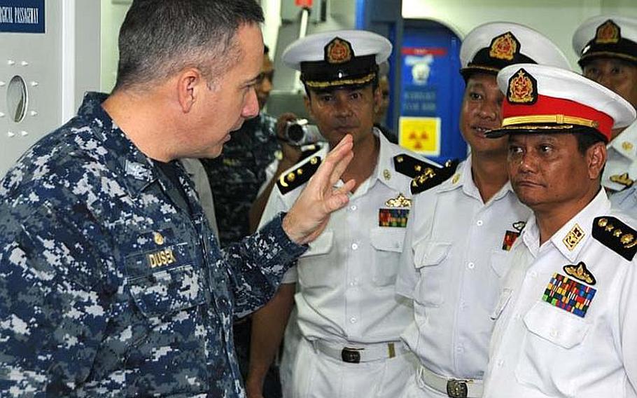 Capt. Daniel Dusek, commanding officer of the amphibious assault ship USS Bonhomme Richard, shows the ship&#39;s medical bay to Myanmar naval officers on Nov. 18, 2012, in the Andaman Sea. Although sanctions prevent a large-scale relationship between the two militaries, the two countries are exploring academic and small-group exchanges.