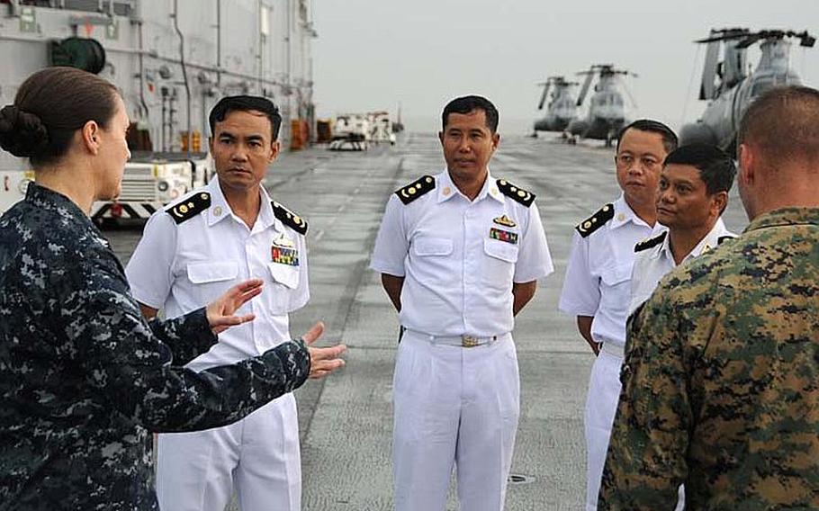 Capt. Heidi Agle, left, deputy commodore of Amphibious Squadron Eleven, discusses the USS Bonhomme Richard&#39;s flight deck during a tour for Myanmar naval officers on Nov. 18, 2012, in the Andaman Sea. The tour preceded President Barack Obama&#39;s speech in Myanmar&#39;s commercial capital of Yangon on Monday. Although sanctions from Washington prevent a large-scale relationship between the two militaries, the two countries are exploring academic and small-group exchanges.