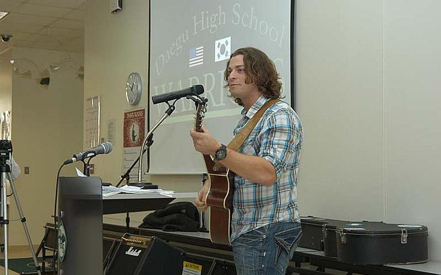 Singer-songwriter Wesley Cook performs for students at Daegu High School on Camp Walker in South Korea Thursday. Cook, 31, of Atlanta, is an up-and-coming performer who attended Department of Defense Dependents Schools as a child.