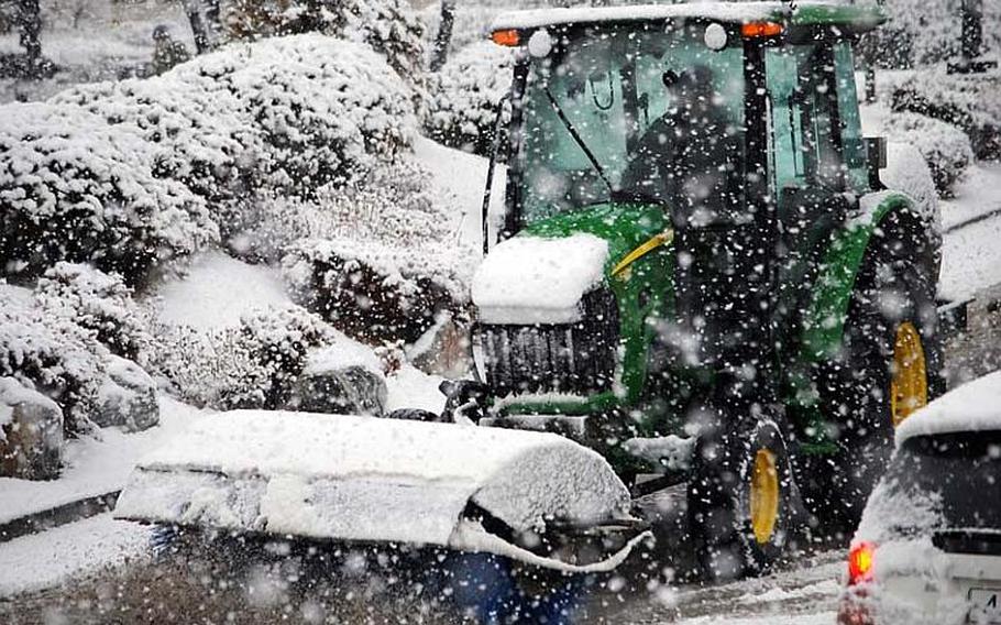 A street sweeper clears snow on Songtan Boulevard at Osan Air Base, South Korea, on Dec. 5, 2012. The heavy snowfall led to limited driving conditions across the base.