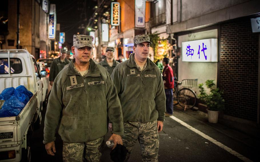 USFJ commander Lt. Gen. Sam Angelella, left, and Col. Mark August, commander of the 374th Airlift Wing, walk through bar row outside Yokota Air Base during a courtesy patrol in late 2012.
