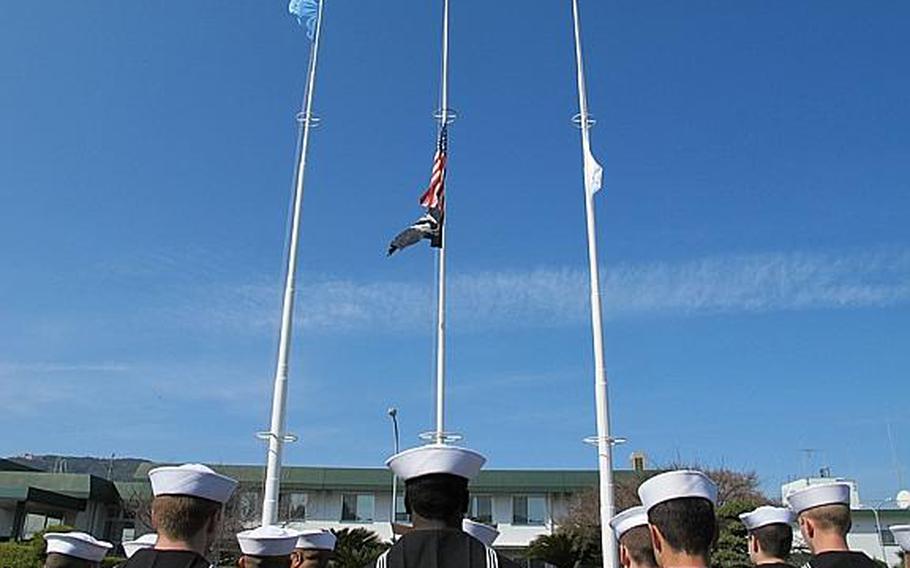 About 40 sailors from various commands along with base leadership gathered at Sasebo Naval Base's Lt. Daniel Godsoe Plaza on the afternoon of March 11, 2013, to commemorate the massive earthquake and tsunami that rocked Japan on March 11, 2011, and to honor its victims.