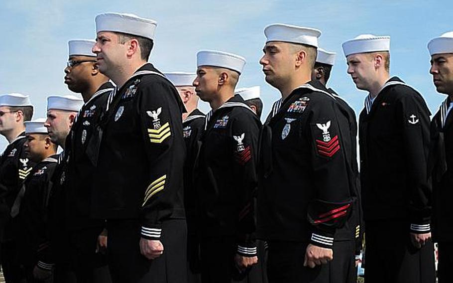 Sailors from various commands observe a moment of silence at Sasebo Naval Base's Lt. Daniel Godsoe Plaza on the afternoon of March 11, 2013, to honor the victims of the massive earthquake and tsunami that rocked Japan on March 11, 2011.