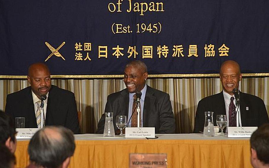 Nine-time Olympic gold medalist Carl Lewis, along with fellow former Olympic athletes Mike Powell, left, and Willie Banks, right, answers questions during a press conference March 25, 2013. The three U.S. athletes, along with Japanese hurdler Dai Tamesue, visited the tsunami-battered Tohoku region of Japan on Saturday and Sunday, where they held a sports summit and held a clinic for young Japanese athletes.