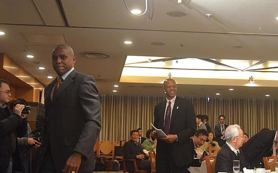 Nine-time Olympic gold medalist Carl Lewis, left, and  fellow former Olympic athlete Willie Banks, right, leave a Tokyo press conference on March 25, 2013. The athletes, along with former U.S. Olympian Mike Powell and former Japanese Olympian Dai Tamesue, visited the tsunami-battered Tohoku region of Japan on Saturday and Sunday, where they hosted a sports summit and held a clinic for young Japanese athletes.

