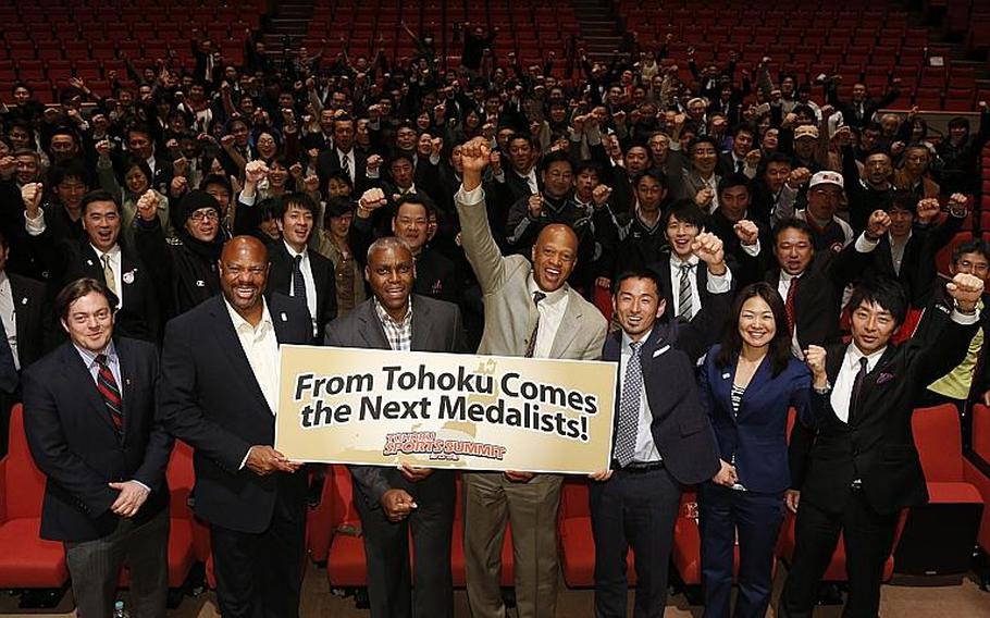 Former U.S. Olympian Mike Powell, second from left, followed by former Olympians Carl Lewis, Willie Banks and Dai Tamesue, encourage coaches and others during a sports summit in Sendai on March 24, 2013.   The athletes visited the tsunami-battered Tohoku region of Japan on Saturday and Sunday, where they discussed how Japan could train its young athletes, and later held a coaching clinic for young Japanese athletes in Ishinomaki.

