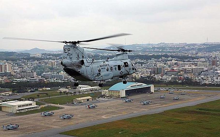 A Sea Knight helicopter flies over Marine Corps Air Station Futenma on Okinawa in November 2012.