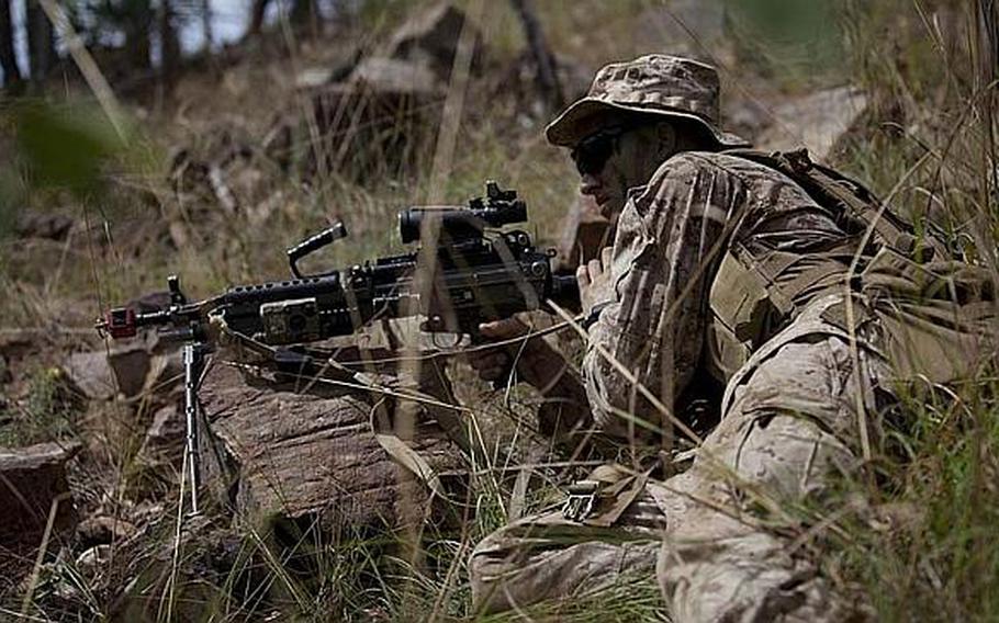 Lance Cpl. Gabriel L. Tennis, an automatic rifleman with the III Marine Expeditionary Force based in Okinawa, analyzes his surroundings during a 2012 exercise in the Australian outback.