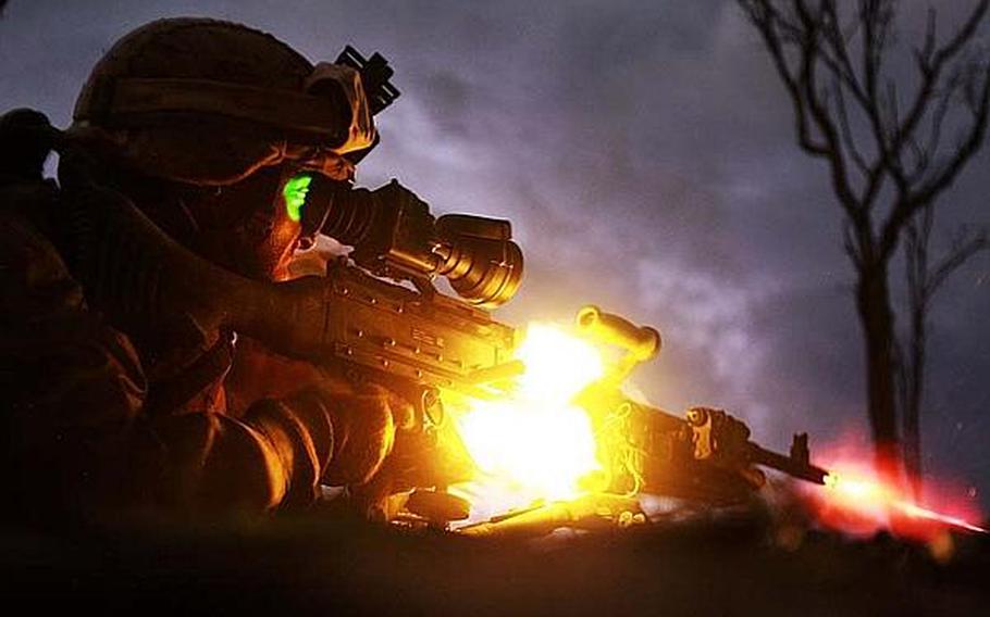Pfc. Sebastian Rodriguez, a machine-gunner with the Marine Corps rotational force in Darwin, Australia, fires his weapon during a night exercise in May 2013.
